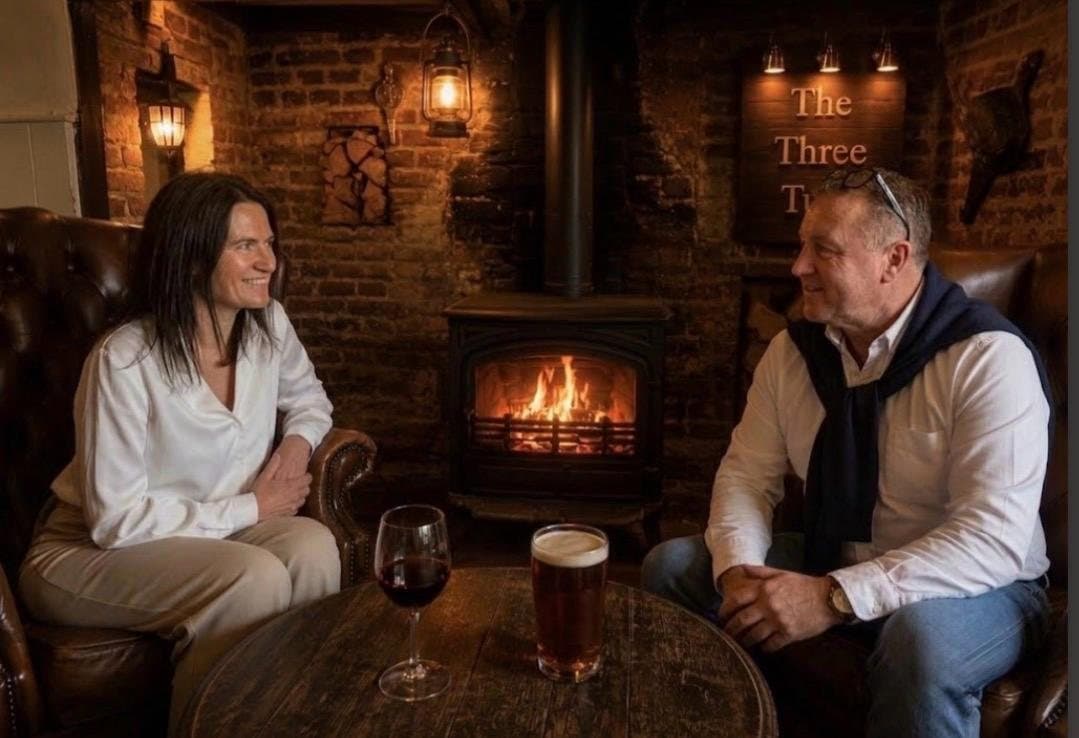 Guests relaxing by the wood-burning stove at The Three Tuns